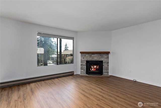 unfurnished living room featuring a fireplace, a baseboard radiator, wood finished floors, and baseboards