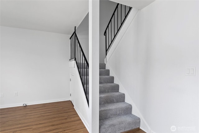 stairs with baseboards and wood finished floors