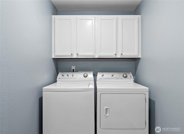 laundry room featuring washer and clothes dryer and cabinet space