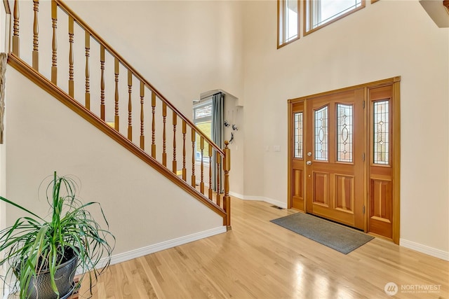 6725 Mirror Ct SE, Olympia, WA 98513 - entrance foyer with a wealth of natural light, a high ceiling, baseboards, and wood finished floors