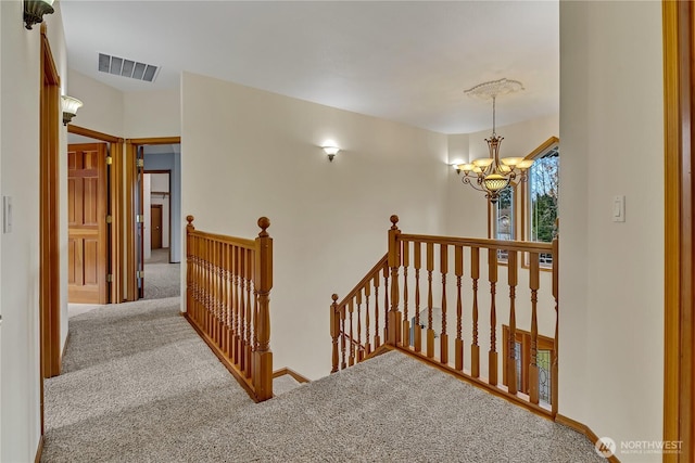 6725 Mirror Ct SE, Olympia, WA 98513 - corridor featuring carpet floors, an upstairs landing, an inviting chandelier, and visible vents