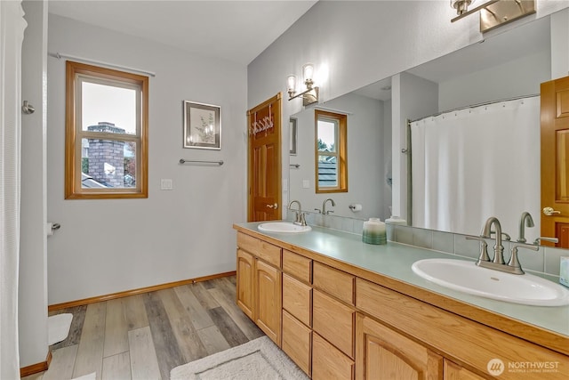 6725 Mirror Ct SE, Olympia, WA 98513 - bathroom featuring double vanity, baseboards, a sink, and wood finished floors