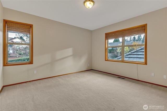 6725 Mirror Ct SE, Olympia, WA 98513 - carpeted spare room featuring visible vents, baseboards, and a healthy amount of sunlight