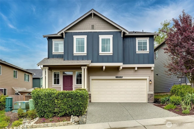 craftsman house featuring a garage, board and batten siding, fence, and concrete driveway