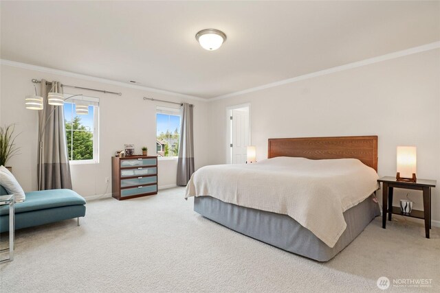 bedroom with crown molding, baseboards, and light colored carpet