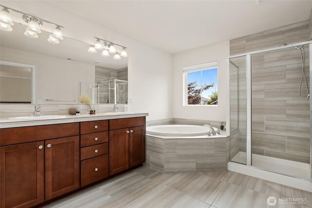 bathroom featuring a sink, double vanity, tile patterned floors, a shower stall, and a bath