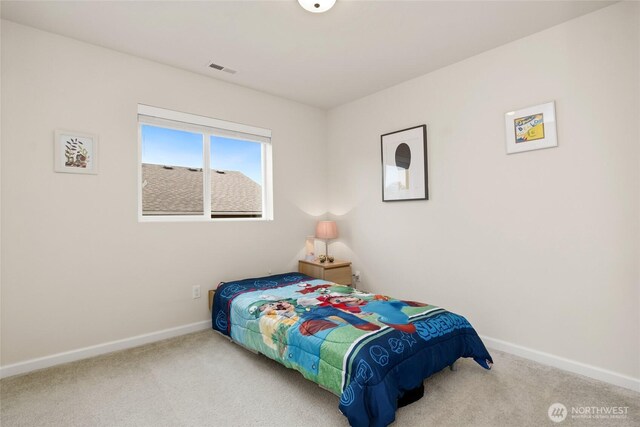 carpeted bedroom with baseboards and visible vents