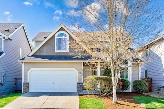 view of front facade featuring stone siding, concrete driveway, and a shingled roof