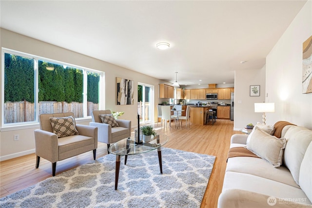 living room featuring light wood-type flooring and baseboards