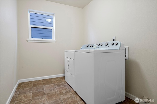 clothes washing area with stone finish flooring, baseboards, laundry area, and independent washer and dryer