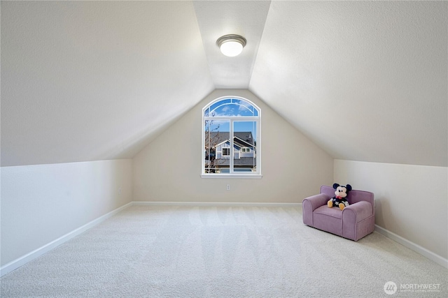 bonus room with vaulted ceiling, carpet floors, and baseboards