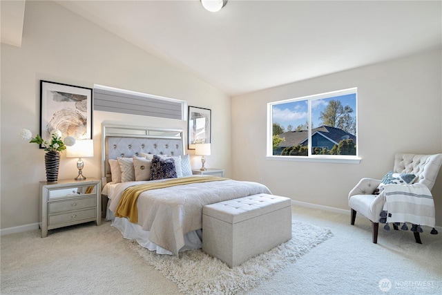 carpeted bedroom with lofted ceiling and baseboards