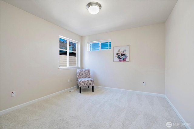 unfurnished room with carpet floors and baseboards