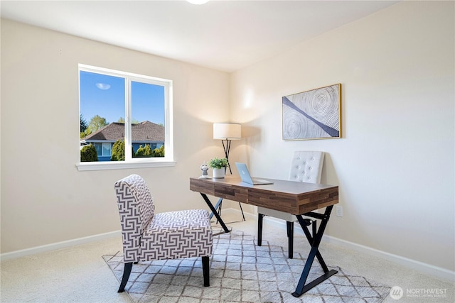 carpeted home office with baseboards
