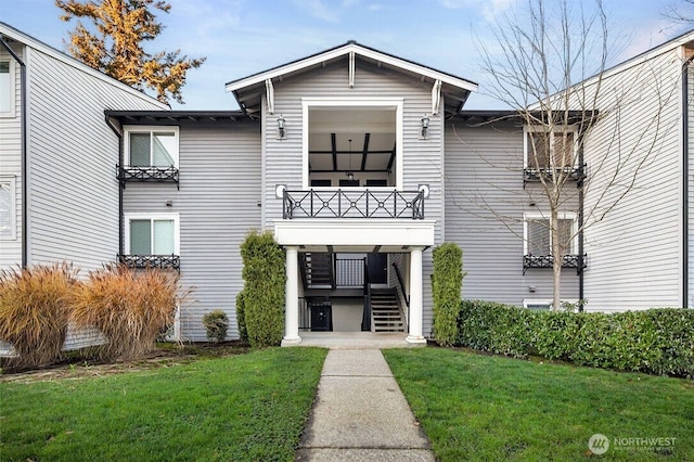 15415 35th Ave W Unit C304, Lynnwood, WA 98087 - view of front of house with a balcony, stairs, and a front yard