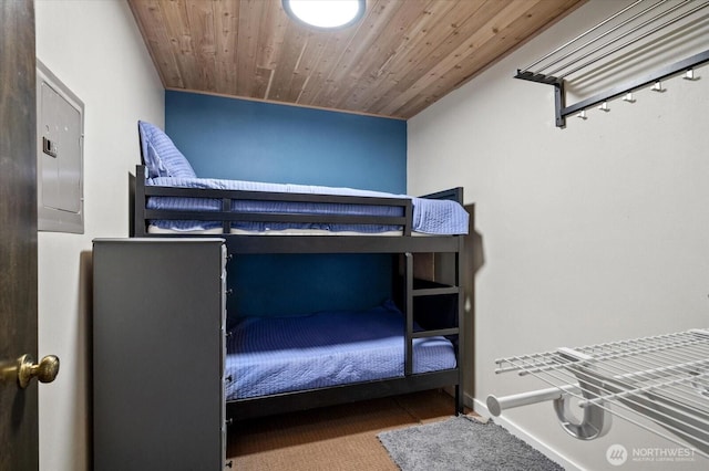 bedroom featuring wooden ceiling and baseboards