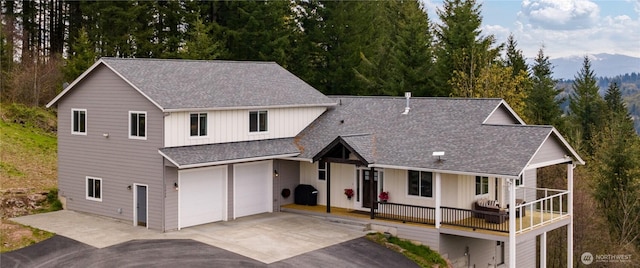 17908 NE 391st St, Amboy, WA 98601 - view of front facade featuring roof with shingles, board and batten siding, an attached garage, aphalt driveway, and covered porch