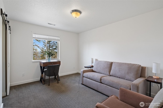 17908 NE 391st St, Amboy, WA 98601 - carpeted living area with a textured ceiling, baseboards, visible vents, and a barn door