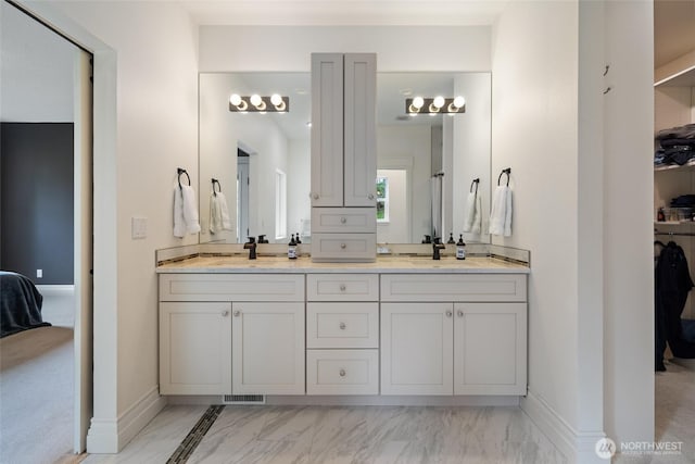17908 NE 391st St, Amboy, WA 98601 - ensuite bathroom featuring a sink, baseboards, double vanity, and marble finish floor