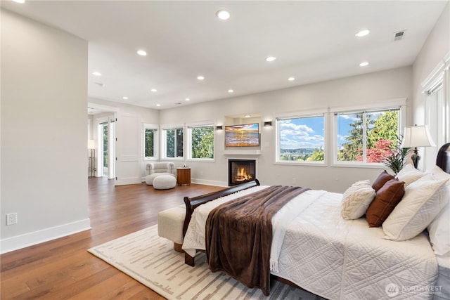 bedroom featuring visible vents, wood finished floors, baseboards, and recessed lighting