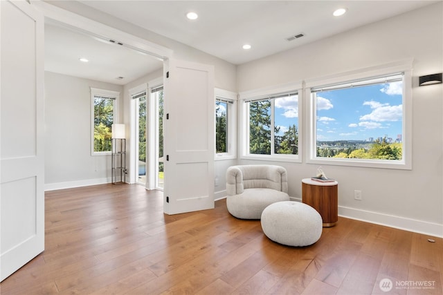 sitting room with recessed lighting, baseboards, visible vents, and light wood-style floors