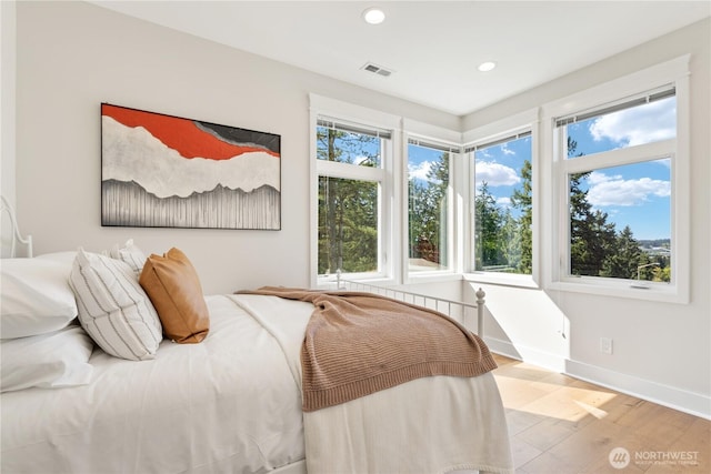 bedroom featuring visible vents, wood finished floors, baseboards, and recessed lighting