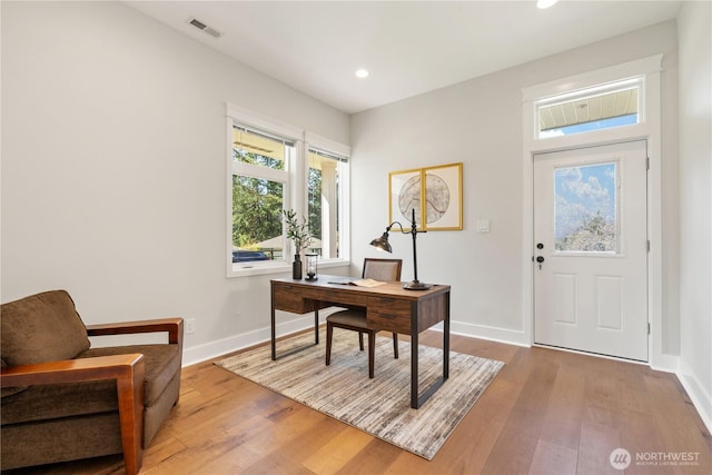 office area with baseboards, recessed lighting, visible vents, and wood finished floors