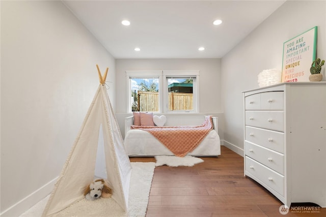 bedroom with baseboards, recessed lighting, and wood-type flooring