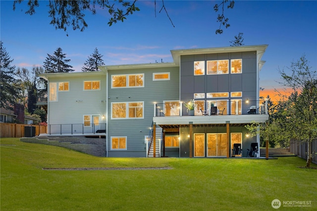 back of house with a lawn, a deck, stairs, and fence