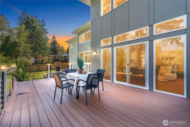 wooden terrace featuring outdoor dining area and fence