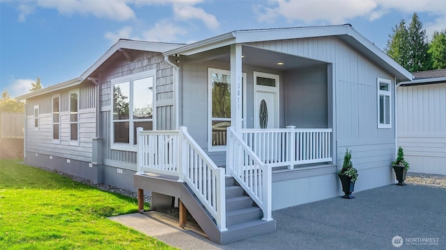 view of front of home with a front yard and crawl space