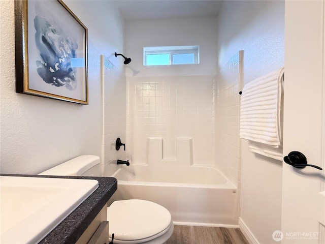 full bathroom featuring toilet, wood finished floors, bathing tub / shower combination, and vanity