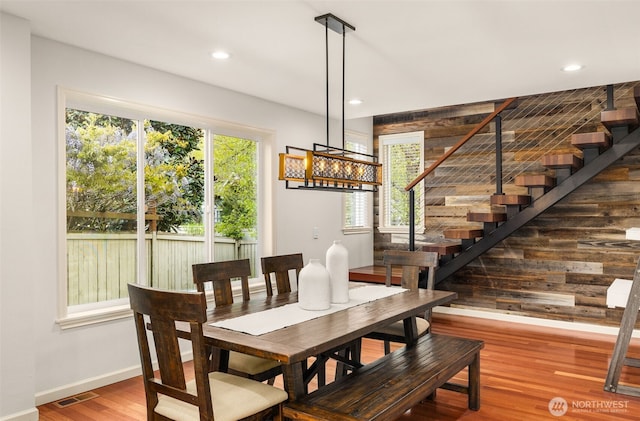 dining space featuring baseboards, wood finished floors, recessed lighting, and stairs