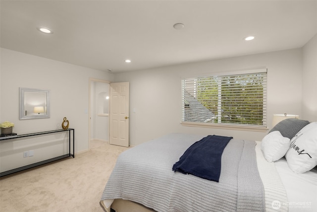 bedroom featuring light carpet and recessed lighting