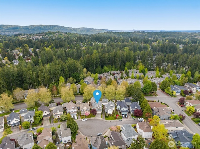 aerial view of property's location with nearby suburban area and a forest