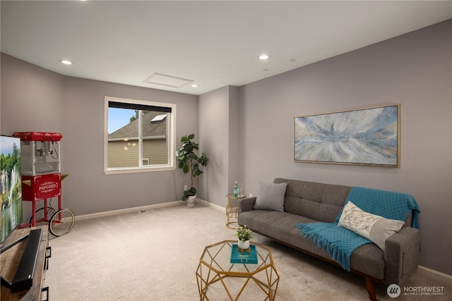 carpeted living room featuring baseboards, attic access, and recessed lighting