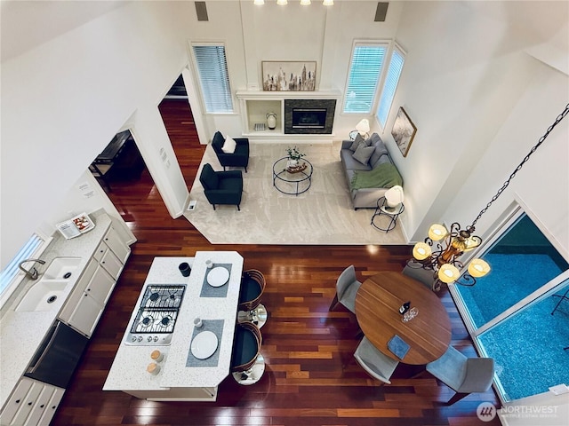 living room with wood finished floors and a tiled fireplace