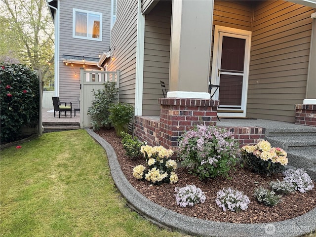 view of exterior entry featuring a yard