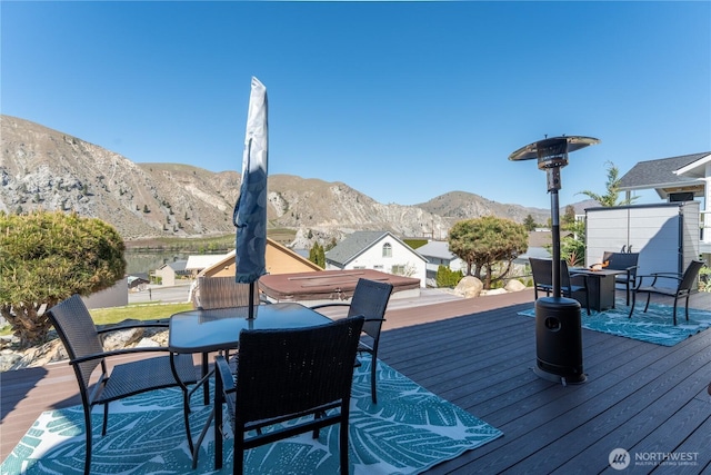 deck featuring outdoor dining space and a mountain view