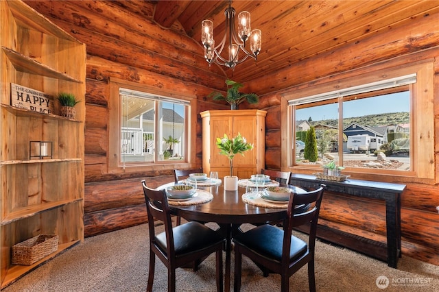 dining room with a notable chandelier, carpet, a wealth of natural light, and rustic walls