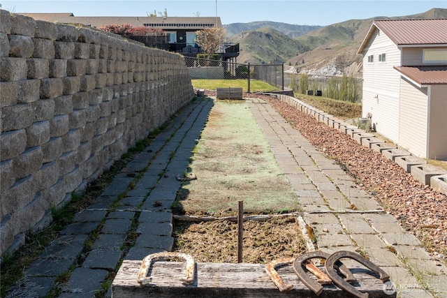 view of yard featuring a fenced backyard and a mountain view