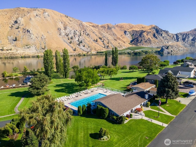drone / aerial view with a water and mountain view