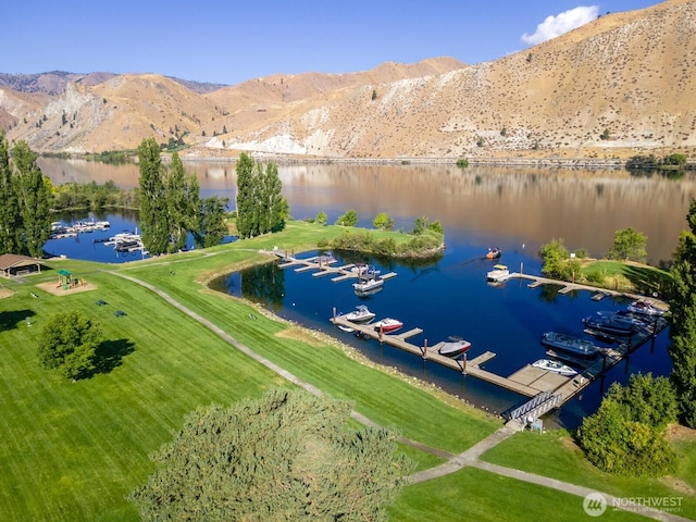 drone / aerial view featuring a water and mountain view