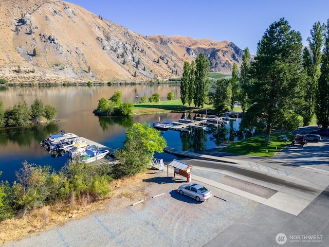 exterior space with a mountain view and a boat dock