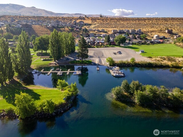 birds eye view of property featuring a water and mountain view and a residential view