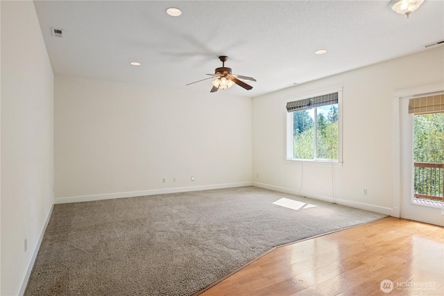 empty room featuring baseboards, visible vents, ceiling fan, and carpet flooring