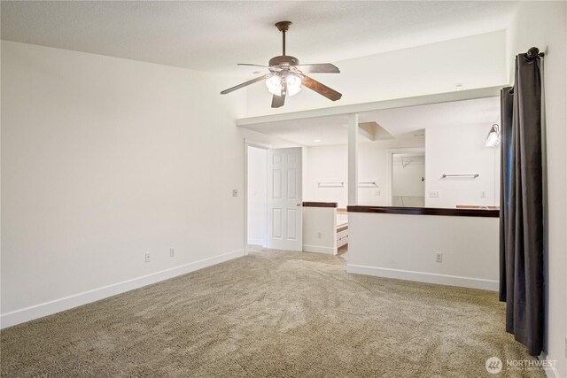 unfurnished room featuring light colored carpet, baseboards, and a ceiling fan
