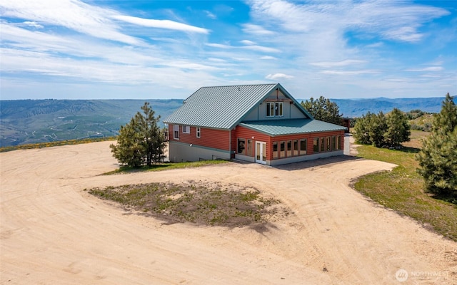 27 Scenic Dr, Brewster, WA 98812 - view of front of property with driveway, a mountain view, and metal roof