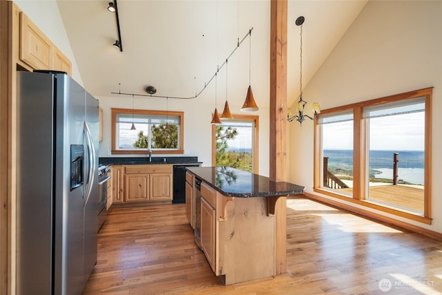 27 Scenic Dr, Brewster, WA 98812 - kitchen featuring stainless steel fridge, light brown cabinets, high vaulted ceiling, light wood-type flooring, and a kitchen island