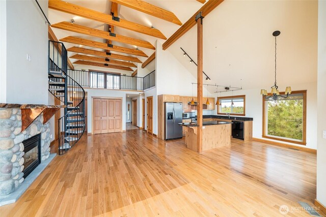 27 Scenic Dr, Brewster, WA 98812 - unfurnished living room featuring high vaulted ceiling, a chandelier, light wood-style floors, beamed ceiling, and stairway